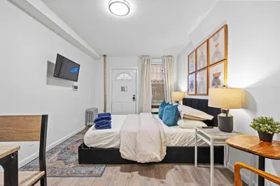 a bedroom with a bed and a table at Highly Recommended Studio Near Times Square in New York