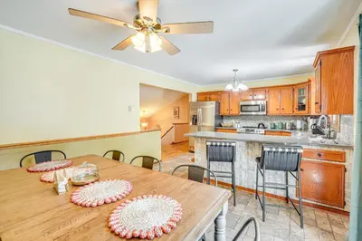 a kitchen and dining room with a table and chairs at Game Room and Private Yard Family Gem in Kunkletown in Effort
