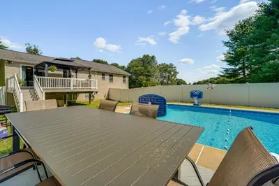 a patio with a table and chairs next to a swimming pool at Game Room and Private Yard Family Gem in Kunkletown in Effort