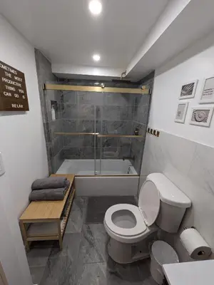 a bathroom with a shower and a toilet and a tub at Extended Family Stay in Passaic