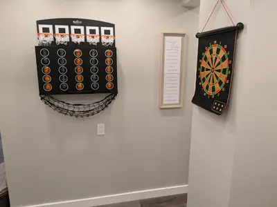 a dart board hanging on a wall next to a dartboard at Extended Family Stay in Passaic