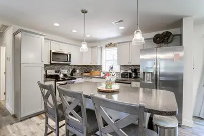 a kitchen with a table and chairs and a refrigerator at NEW Construction - 7 Bedroom Log Cabin in Blakeslee