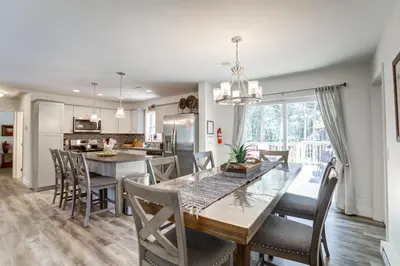 a kitchen and dining room with a table and chairs at NEW Construction - 7 Bedroom Log Cabin in Blakeslee