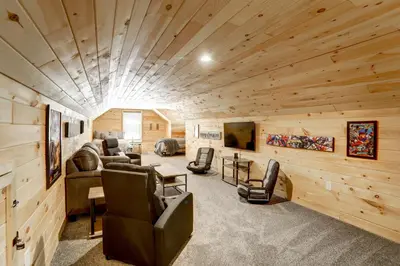 a large living room with wood paneling and a ceiling at NEW Construction - 7 Bedroom Log Cabin in Blakeslee