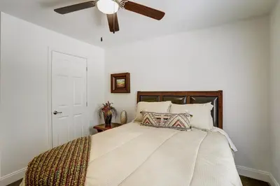 a bedroom with a bed with a ceiling fan at NEW Construction - 7 Bedroom Log Cabin in Blakeslee