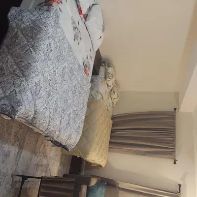 a bedroom with two pillows and a bed at Double queen room 6 minutes walk to Penn station NYC EWR in Jersey City