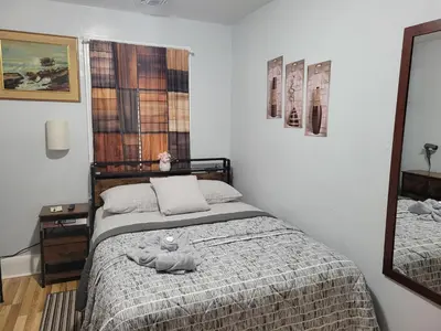 a bedroom with a bed with a stuffed animal on it at Comfortable in Roselle