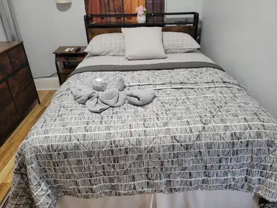 a bedroom with a bed with two stuffed animals on it at Comfortable in Roselle