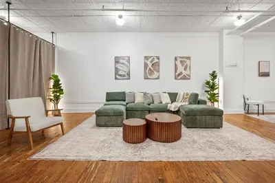 a living room with a couch and a table at Massive SoHo Loft 4 Bedrooms 2 Bath 8 beds in New York