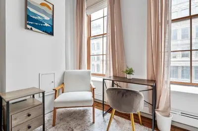 a room with a desk and a chair and a table at Massive SoHo Loft 4 Bedrooms 2 Bath 8 beds in New York