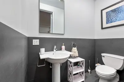 a bathroom with a white sink and a toilet at Massive SoHo Loft 4 Bedrooms 2 Bath 8 beds in New York