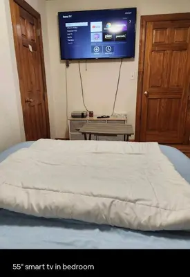 a bedroom with a bed with a tv on the wall at Conveniently located in the heart of the city in New York