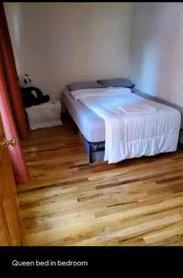 a bed in a bedroom with a wooden floor at Conveniently located in the heart of the city in New York