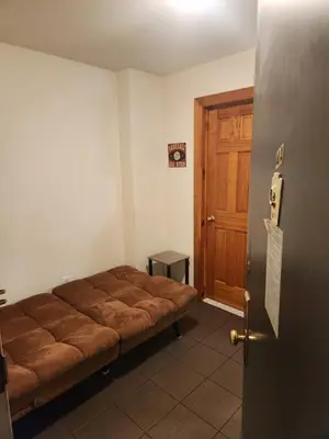 a bed in a room with a wooden door at Conveniently located in the heart of the city in New York