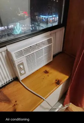 an air conditioner sitting on a table under a window at Conveniently located in the heart of the city in New York