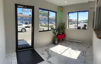 a front door of a store with windows at Ritz Motel in Elizabeth