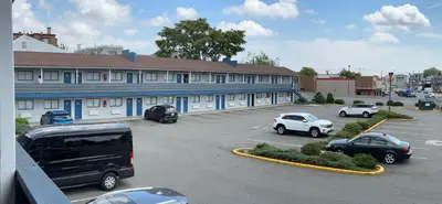 a building with cars parked in a parking lot at Ritz Motel in Elizabeth