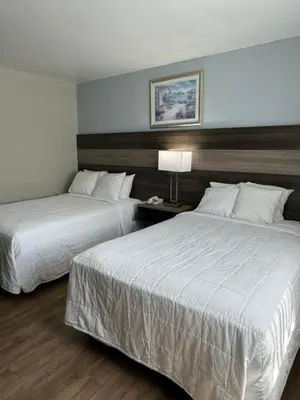 a hotel room with two beds and a lamp at Ritz Motel in Elizabeth