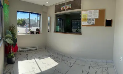 a waiting room with a mirror and a window at Ritz Motel in Elizabeth