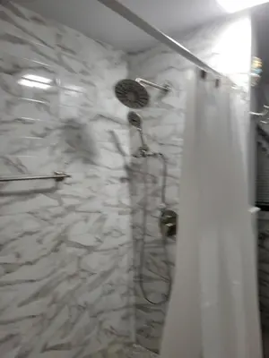 a bathroom with a shower with a shower curtain at New bedroom in Roselle