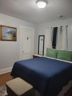 a bedroom with a blue bed and a chair at New bedroom in Roselle