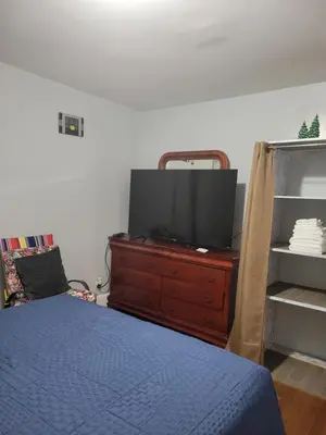 a bedroom with a bed and a tv on a dresser at New bedroom in Roselle