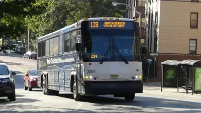a bus is driving down a city street at NYC Loft Studio Near MetLife World Cup Stadium & Times Square in North Bergen