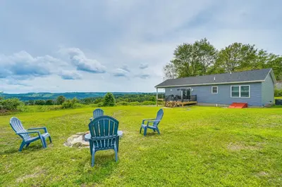 three chairs sitting in a yard in front of a house at Comfortable Muncy Home with Serene Views! in Muncy