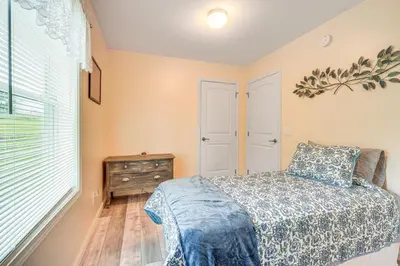 a bedroom with a bed and a dresser and a window at Comfortable Muncy Home with Serene Views! in Muncy