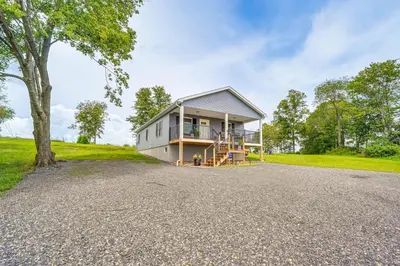 a house on a hill with a tree at Comfortable Muncy Home with Serene Views! in Muncy
