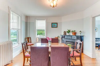 a dining room with a table and a fireplace at Walk to Hudson River Pet-Friendly Home with Views! in Newburgh
