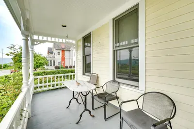 a porch with two chairs and a table at Walk to Hudson River Pet-Friendly Home with Views! in Newburgh