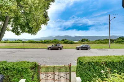 two cars parked in a parking lot at Walk to Hudson River Pet-Friendly Home with Views! in Newburgh
