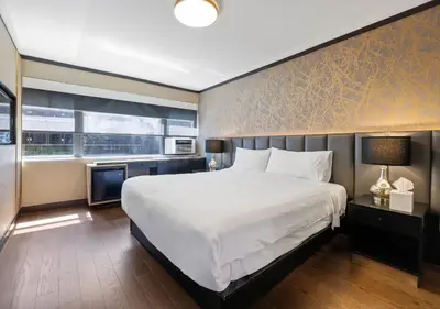 a bedroom with a large white bed and a window at Hudson Yards Hotel in New York