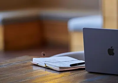 a laptop computer sitting on top of a wooden table at Hudson Yards Hotel in New York