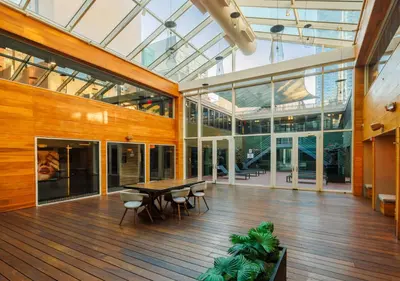 a large room with a table and chairs and glass ceilings at Hudson Yards Hotel in New York