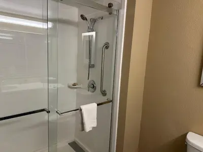 a shower with a glass door in a bathroom at Wingate by Wyndham Harrisburg Near Hershey in Harrisburg