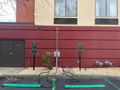 a building with a parking lot with a parking meter at Wingate by Wyndham Harrisburg Near Hershey in Harrisburg