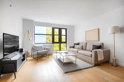 a living room with a couch and a tv at LES 1br w gym doorman wd nr park NYC-1314 in New York