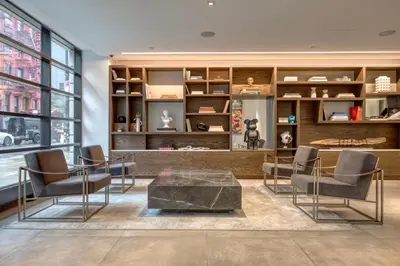 a living room with chairs and a table in a building at LES 1br w gym doorman wd nr park NYC-1314 in New York