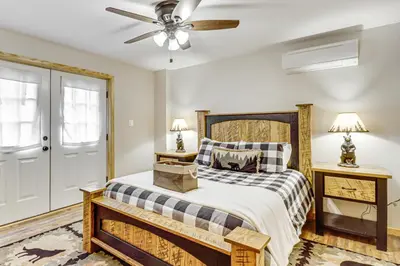 a bedroom with a bed and a ceiling fan at Forest Views and Hot Tub Poconos Cozy Cabin in Albrightsville