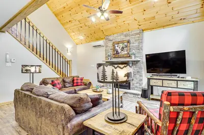 a living room with a couch and a tv at Forest Views and Hot Tub Poconos Cozy Cabin in Albrightsville