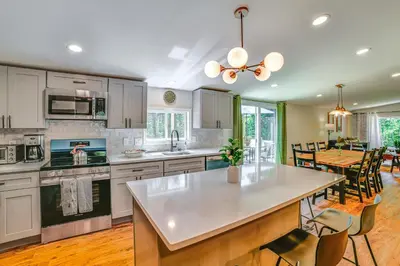 a kitchen and dining room with a table and chairs at Nature Escape in Unadilla Modern Home with 2 Decks in Unadilla