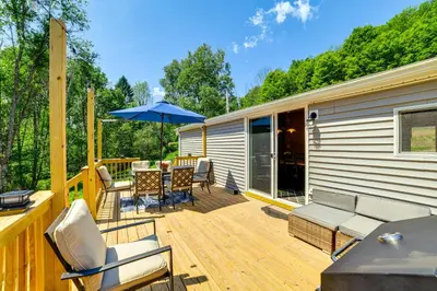 a deck with a table and chairs and an umbrella at Nature Escape in Unadilla Modern Home with 2 Decks in Unadilla