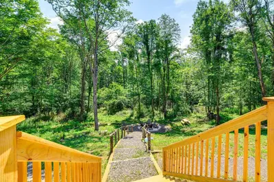 a view from the porch of a cabin with a wooden deck at Nature Escape in Unadilla Modern Home with 2 Decks in Unadilla