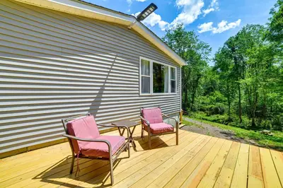 two pink chairs and a table on a deck at Nature Escape in Unadilla Modern Home with 2 Decks in Unadilla