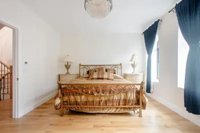 a bedroom with a bed and a chandelier at Little manhattan near Time Square in New York