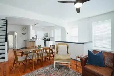 a kitchen and living room with a table and chairs at Large Bi-level Apartment in Heart of Manayunk in Bala-Cynwyd