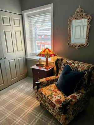 a living room with a couch and a lamp on a table at Large Bi-level Apartment in Heart of Manayunk in Bala-Cynwyd