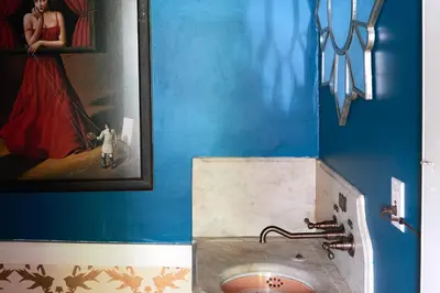 a bathroom with a sink and a picture of a woman at Ulster County Farmhouse Near Waterfalls and Winery! in Pine Bush